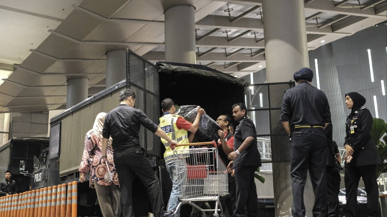 Malaysian police recall overflowing cash, gems in 1MDB raid on Najib-linked condo