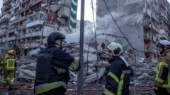 Rescuers search rubble of Kyiv flats after massive Russian strikes kill two