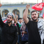 What slogans do the mourning crowds chant?