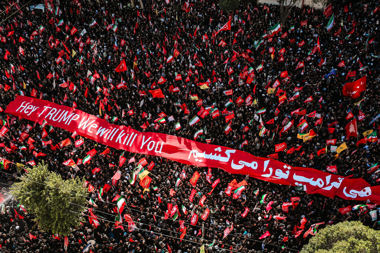 With fists raised and vows of vengeance, millions entomb their martyred Leader