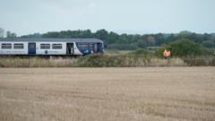 Man dies after train hits van on level crossing